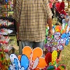 Man selling colorful gadgets at garden show 